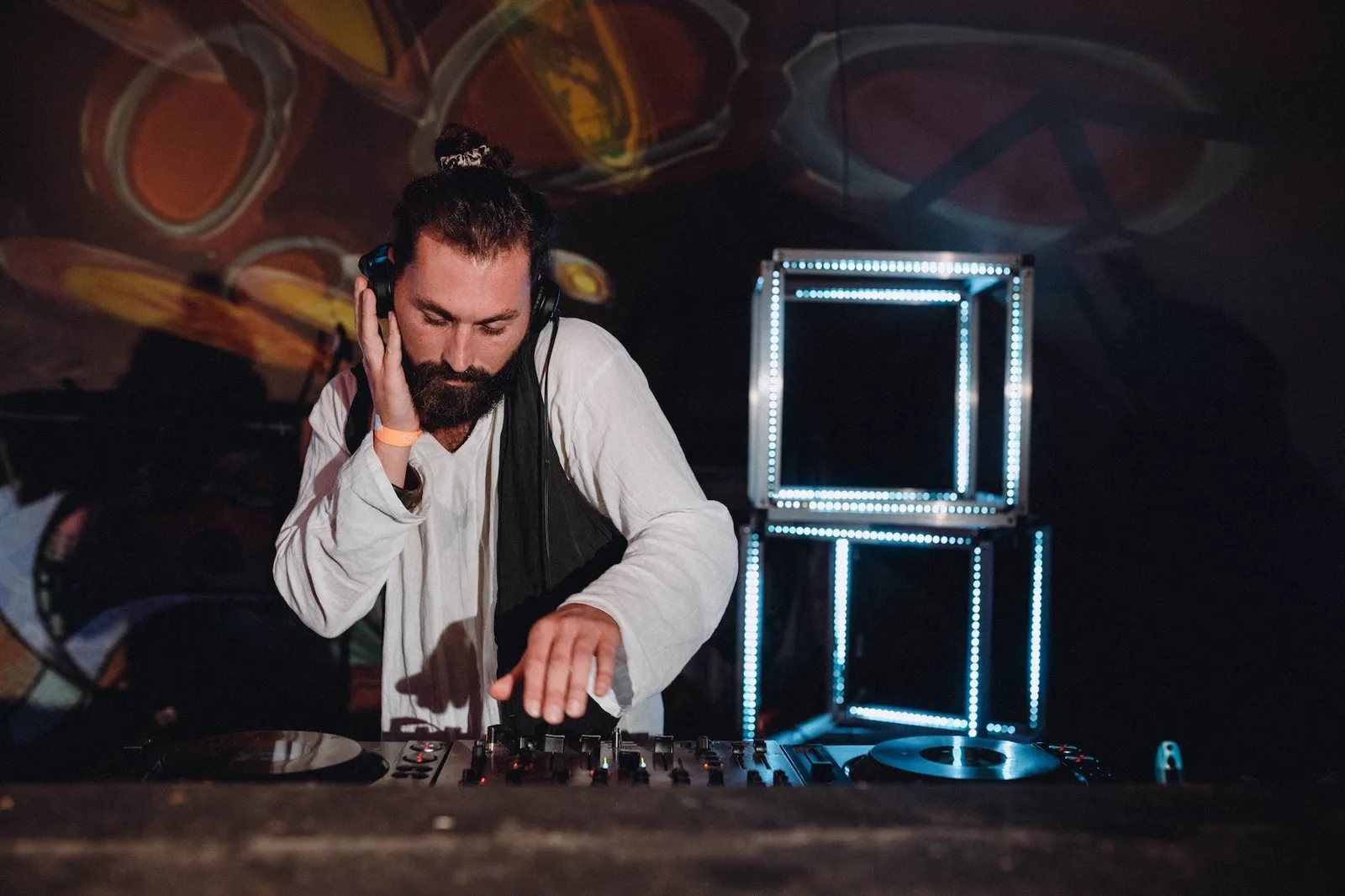 Oskabya at the mixer, framed by cubes of light